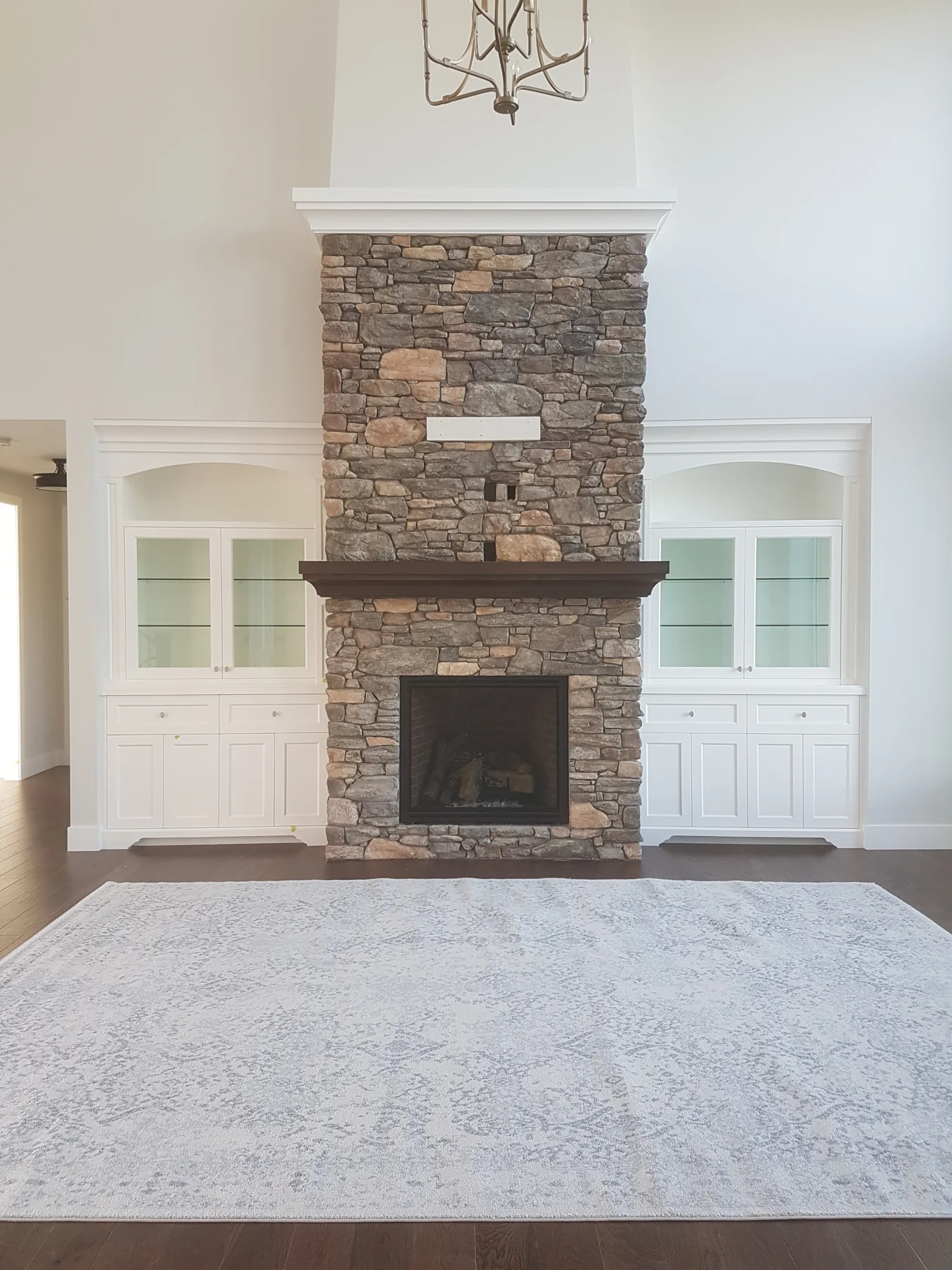 Bright room with painted fireplace surround and built-in cabinetry