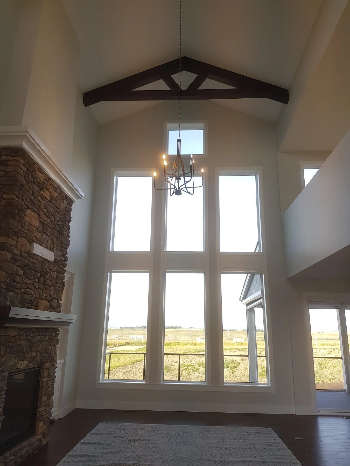 Tall vaulted interior with large windows and freshly painted walls